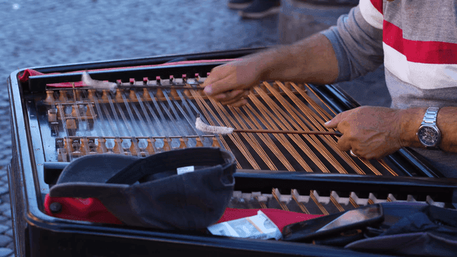 Musician playing yanggeum outdoors