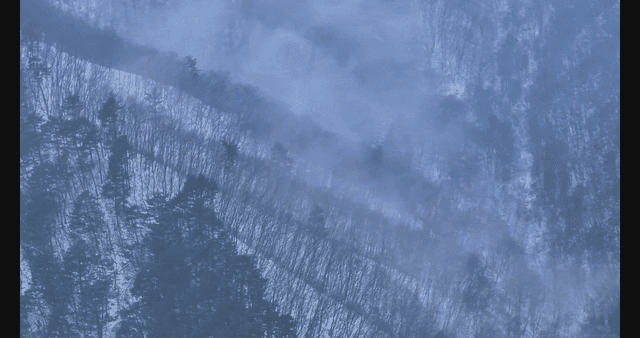 Snow-covered mountain with mist