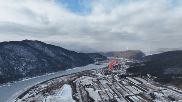 Snow-covered mountains and a paraglider