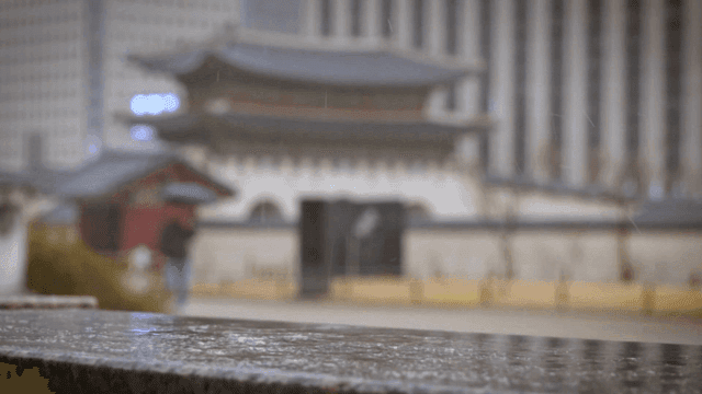 In front of traditional main gate on rainy day