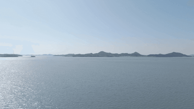 Calm sea with island visible in distance