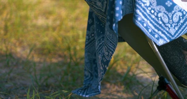 Patterned Blue Fabric Draped Over Camping Chair