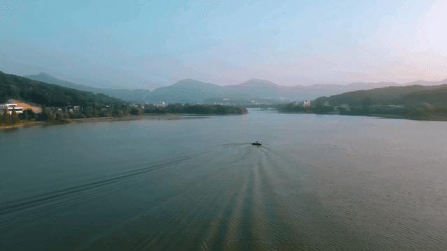 Tranquil lake with mountains visible in distance