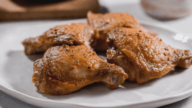 Juicy roasted chicken thighs on a plate