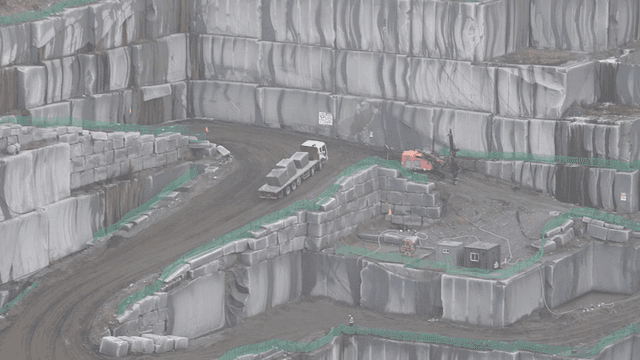 Quarry with trucks and machinery.