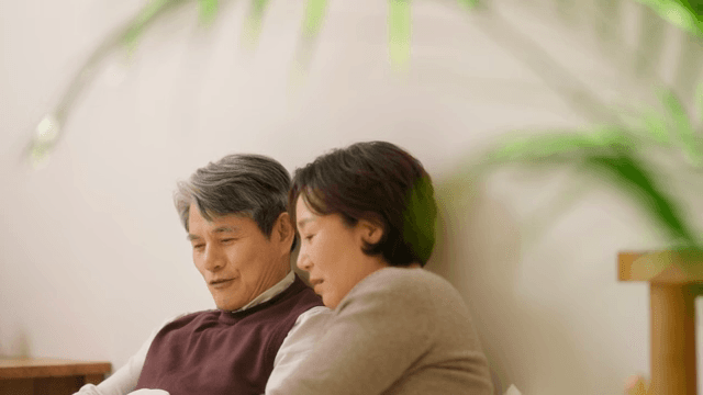 Elderly couple sitting together in bed