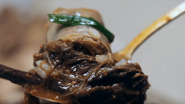 A spoonful of sundae soup with bracken fern