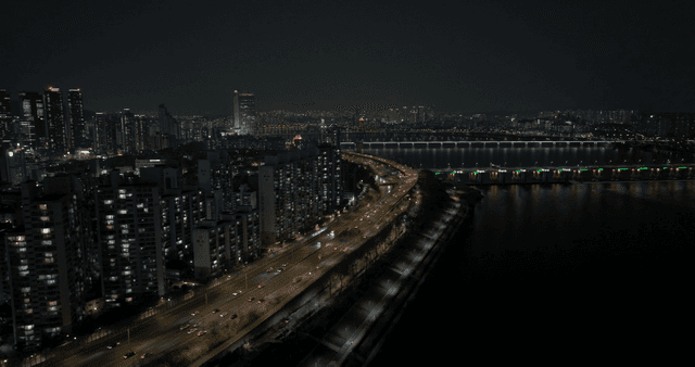 Night view of a city with a river and bridge