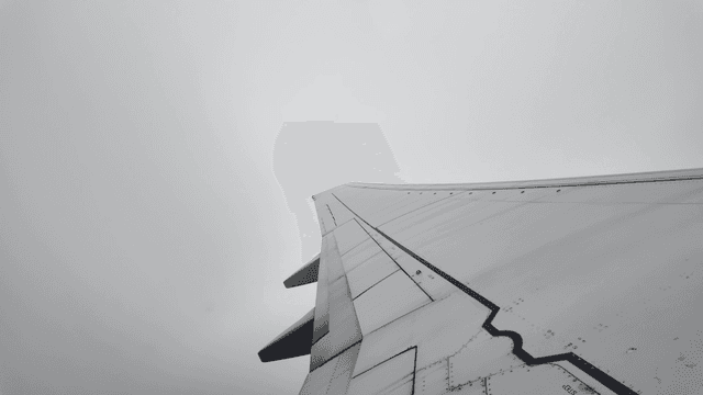 View of an airplane wing above the clouds