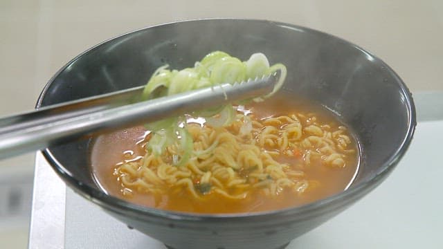 Steaming bowl of ramen with green onions