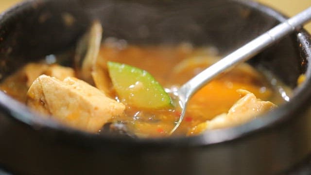 Soybean paste stew with freshwater snail, tofu and vegetables