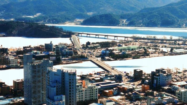 Cityscape with river and snow-covered landscape