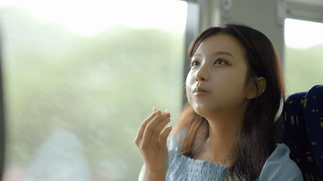 Woman eating eggs on a train