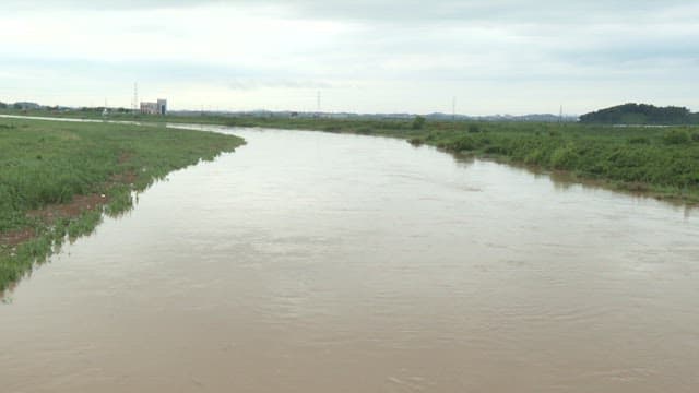 Overcast Sky Over Tranquil Riverside Landscape