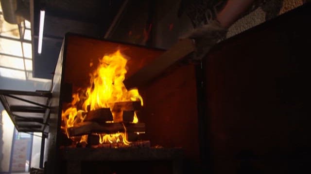 Grilling and Sizzling Meat Over Flaming Grill