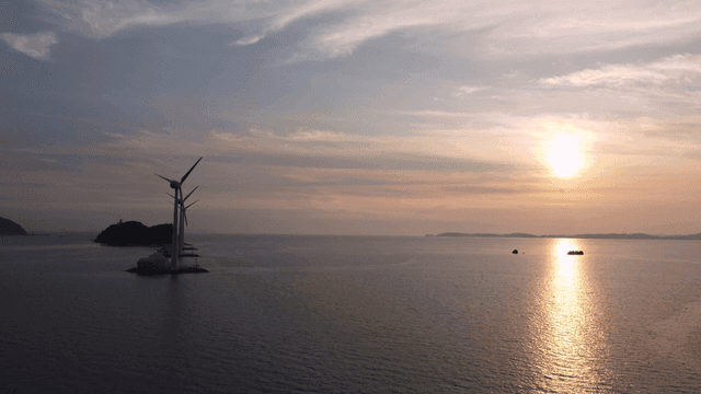 Wind turbines on sea at sunrise