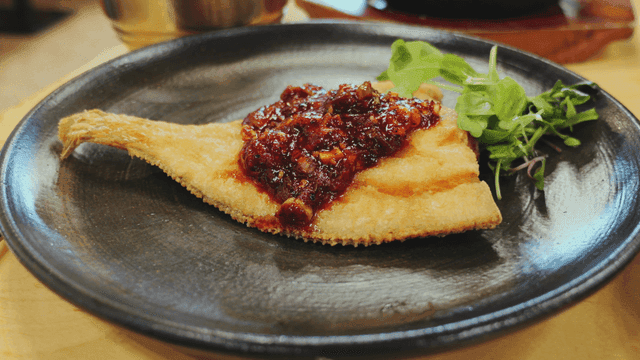 Fried halibut with spicy sauce and greens