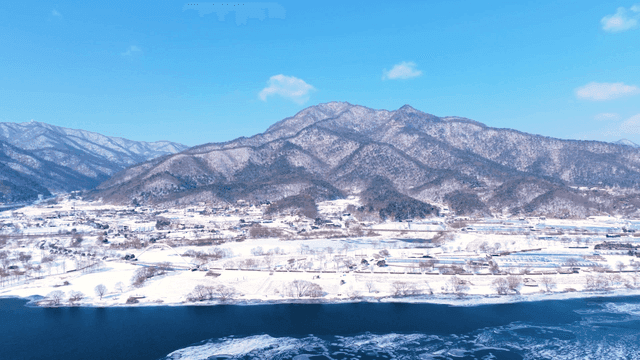 Snow-covered mountains and village