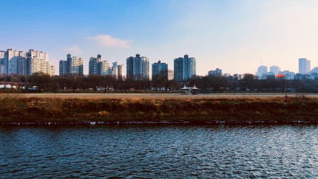 Dense Cityscape with a River Flowing in Front