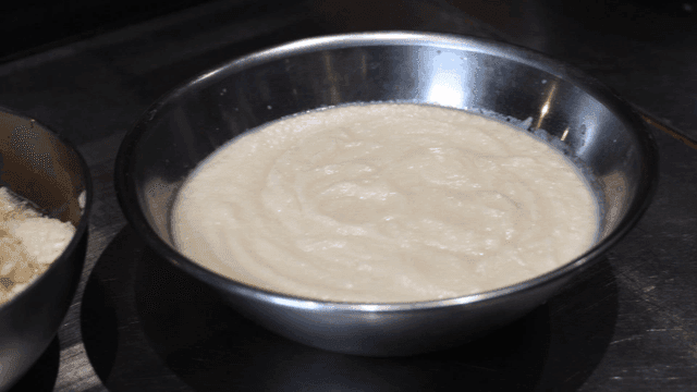 Two bowls of finely crushed garlic on table