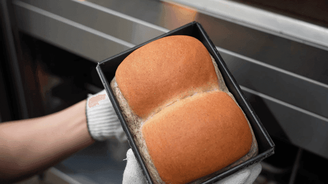 Freshly baked bread taken out of oven
