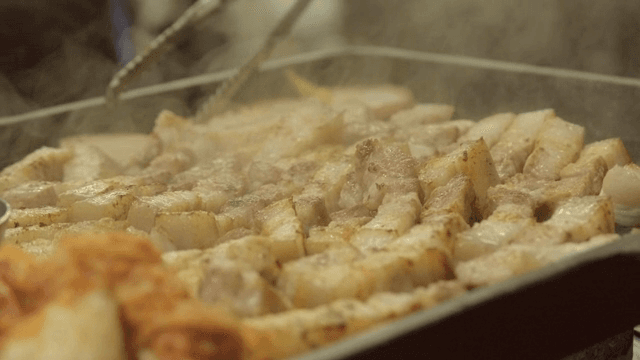 Grilled pork belly with kimchi on a grill