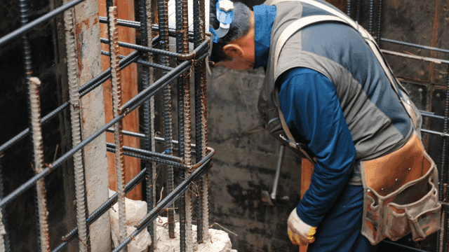 Worker using a hammer on a construction site
