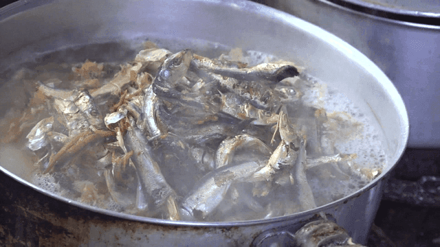 dried anchovy added into boiling broth pot