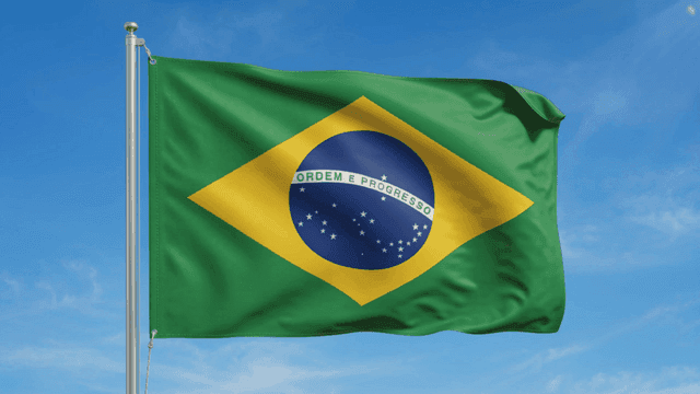 Brazilian flag waving against a clear sky
