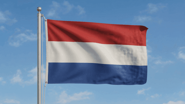 Dutch flag fluttering against clear sky