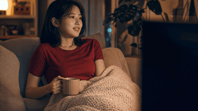 Woman relaxing on sofa holding mug