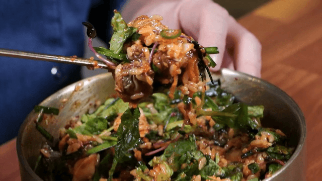 Mixing Korean bibimbap in a bowl