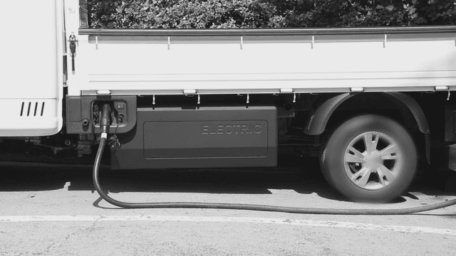 Electric truck charging outdoors