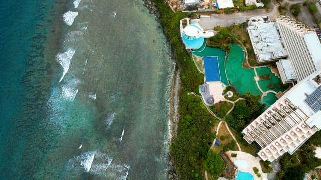 Hotel with a Swimming Pool and a Beach with Waves