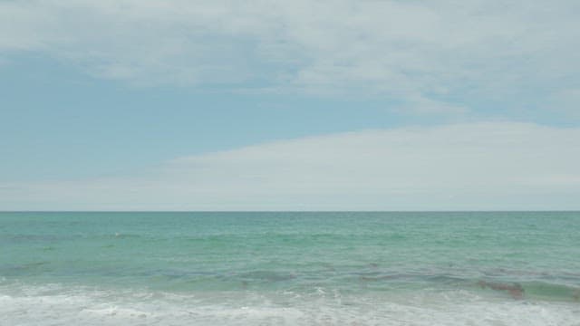 Serene Beach with Gentle Waves and Clear Sky