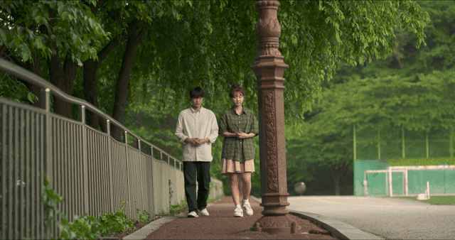 Awkward man and woman walking together on street
