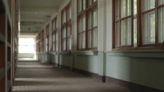 복도에 선 여성을 비추다 지지직거리는 화면