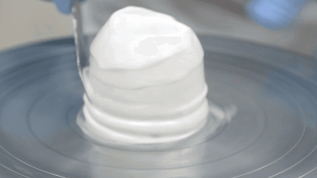 Cream being spread on a cake