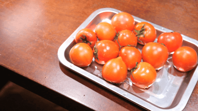 Fresh tomatoes on a metal tray