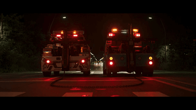 Night road where tow trucks start moving