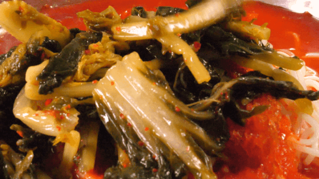 Young radish kimchi placed on top of noodles