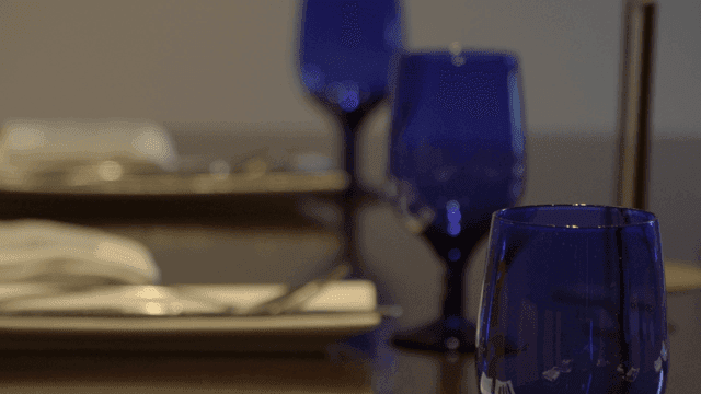 Blue wine glasses on a dining table