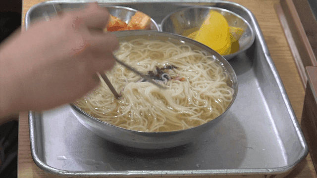 Bowl of banquet noodles with side dishes