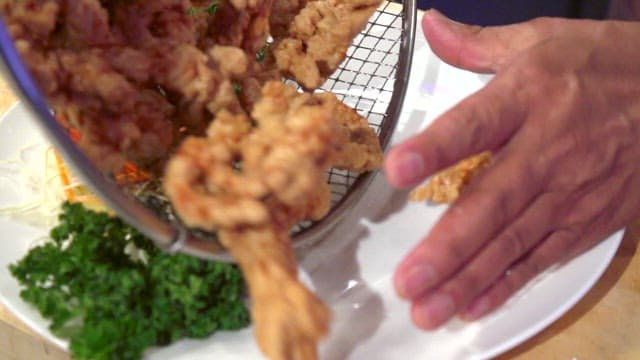 Fried pork being plated