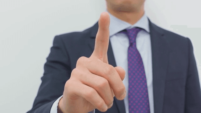 Businessman Gesturing Instruction with His Finger