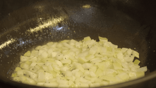Chopped onions sizzling in a pan