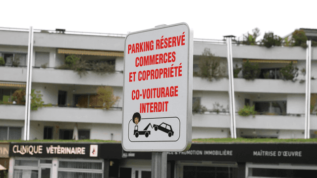 Parking sign in front of European apartment building