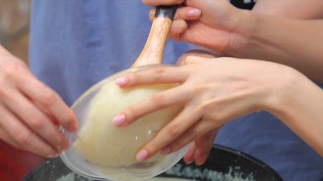 Adding boiled and mashed potatoes to the boiling soup